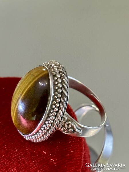 A beautiful silver ring, decorated with a large tiger's eye stone