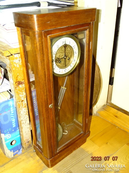 Antique chiseled wall clock mechanism with walker in plain case