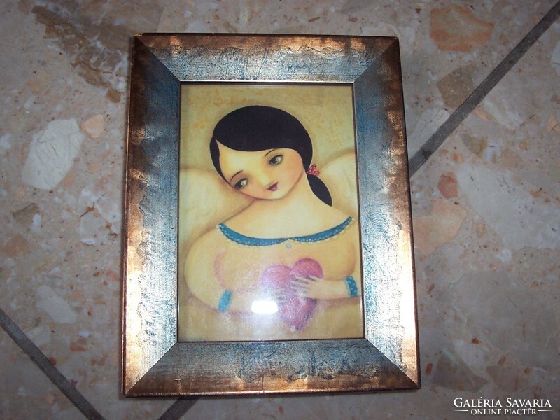 Little girl in heart picture frame