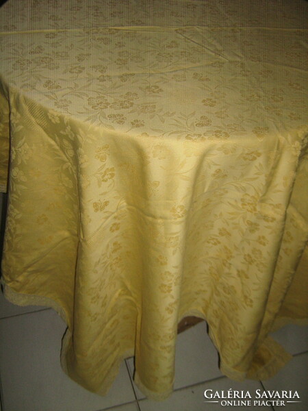 Beautiful golden yellow damask tablecloth with a rich flower and Toledo pattern with a lace edge