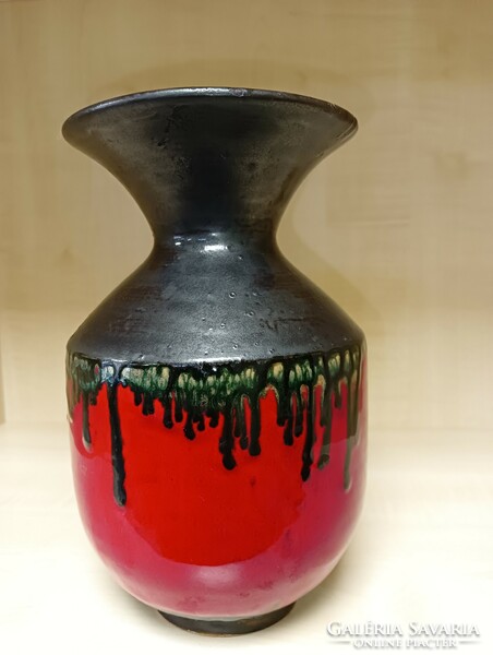 A red-black ceramic vase with a trickled glaze