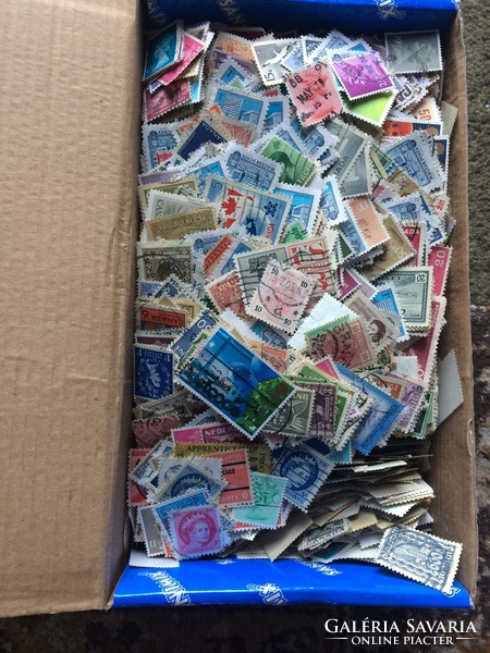 Many thousands of stamps in bulk in boxes