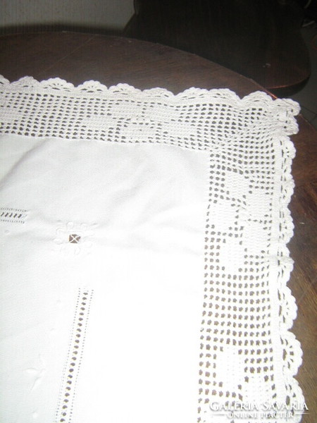 Beautiful hand-crocheted snow-white hand-embroidered azure tablecloth