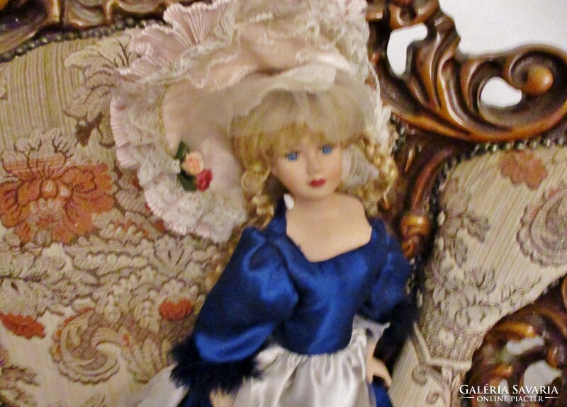 Old doll with big porcelain head in nice clothes