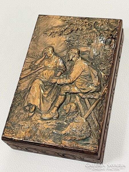 Old wooden box with copper relief pattern