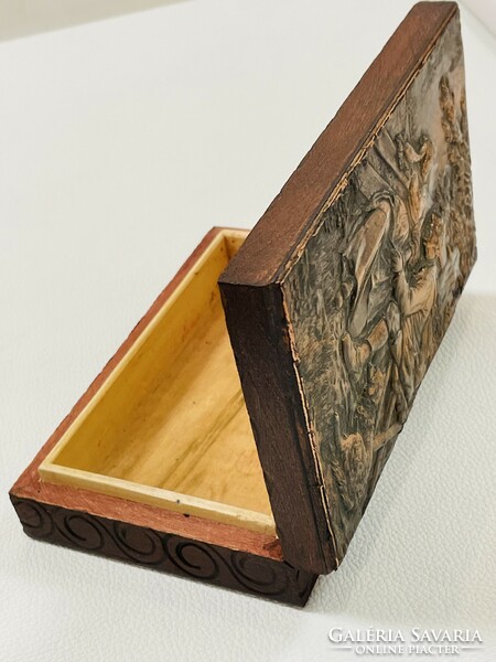 Old wooden box with copper relief pattern