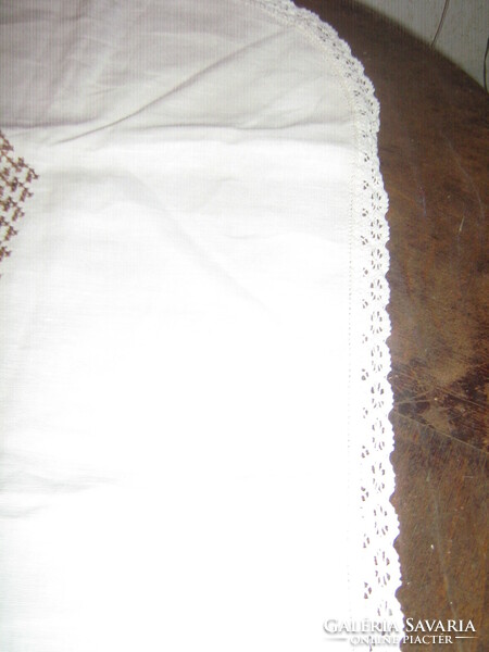 Beautiful hand-embroidered cross-stitch tablecloth with a lace edge
