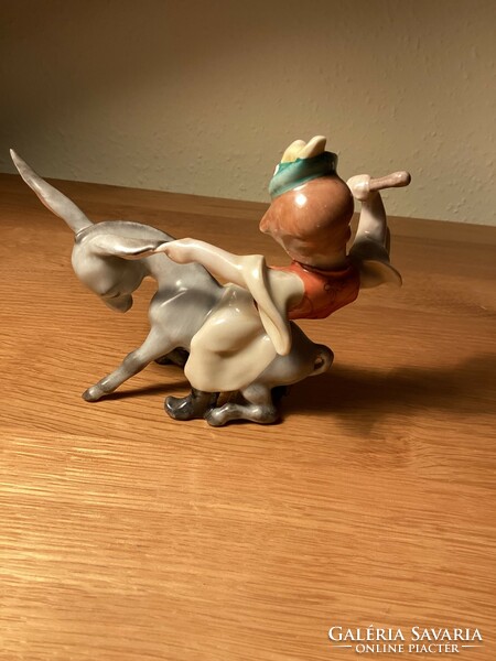 Herend porcelain boy sitting on a donkey.