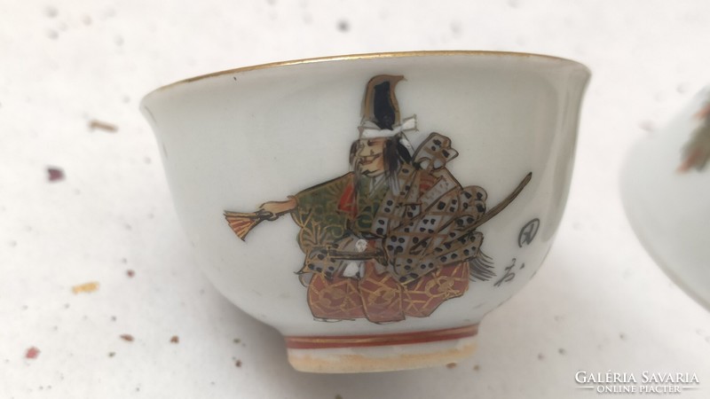 A pair of Japanese sake cups with figures from the no theater