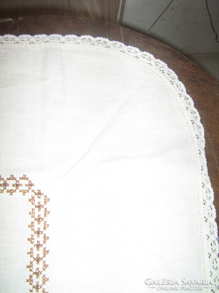Beautiful hand-embroidered cross-stitch tablecloth with a lace edge