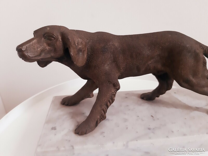 Old bronze hunting dog on a marble plinth