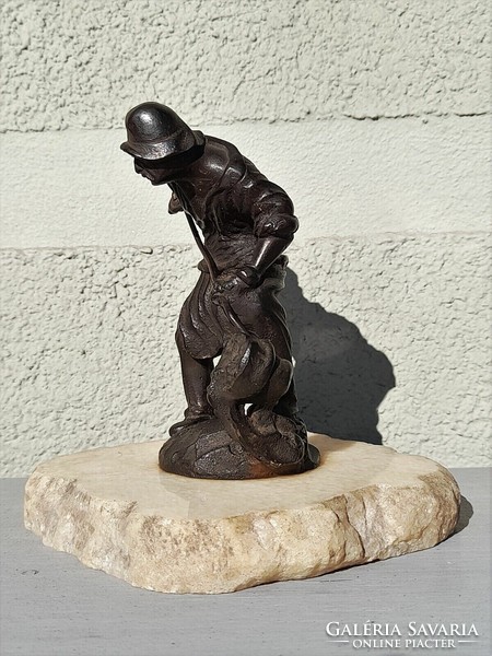 Antique cast iron foundry worker statue on a marble plinth marked 