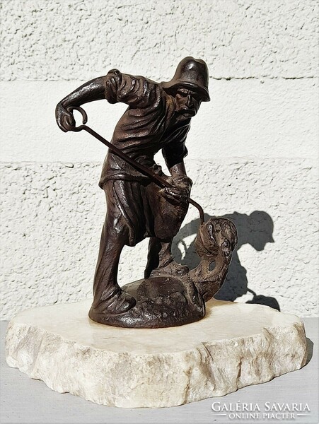 Antique cast iron foundry worker statue on a marble plinth marked 