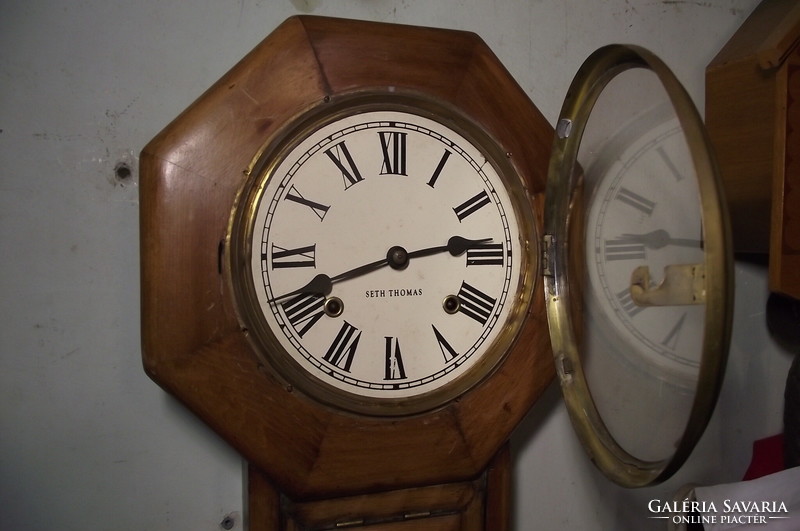 Antique, octagonal swing wall clock.