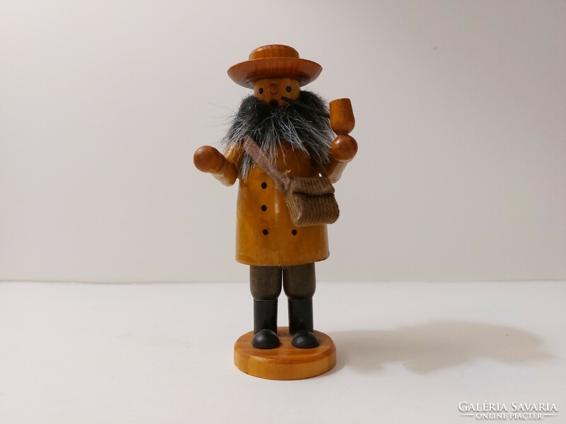Smoking wooden figure bearded man