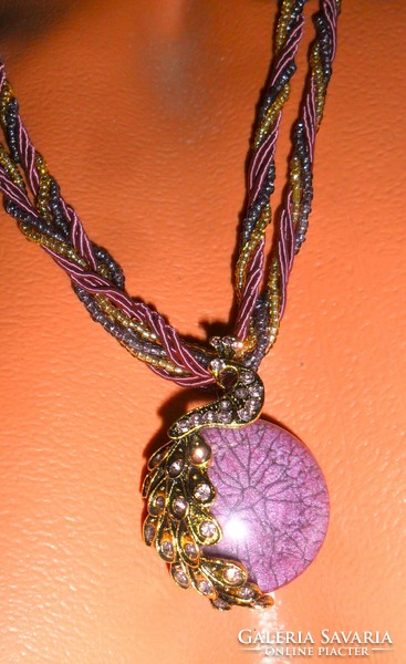 Bronze peacock pendant, encrusted with zirconia, purple colored, twisted pearl-silk necklace.