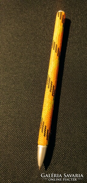 An old ballpoint pen covered in some kind of fabric..