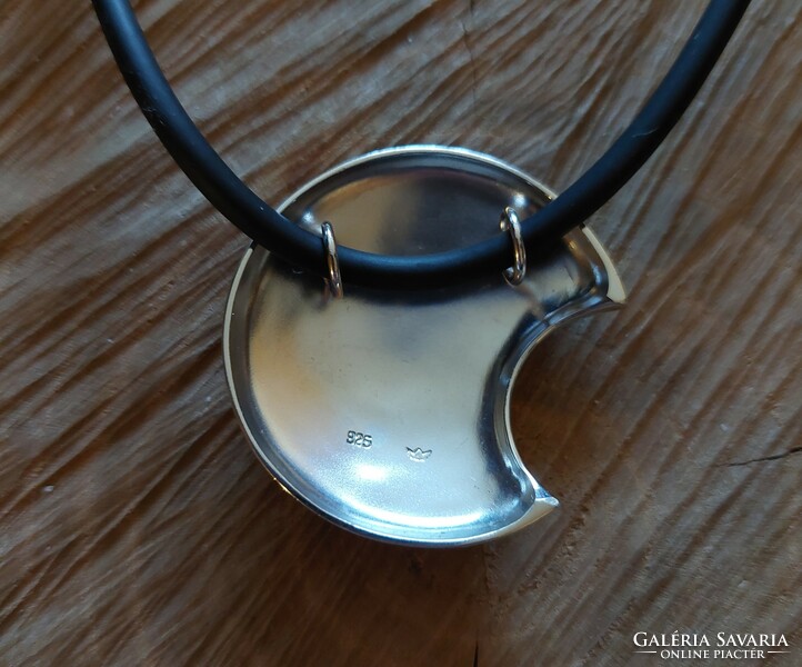 A very special silver moon pendant on a rubber chain