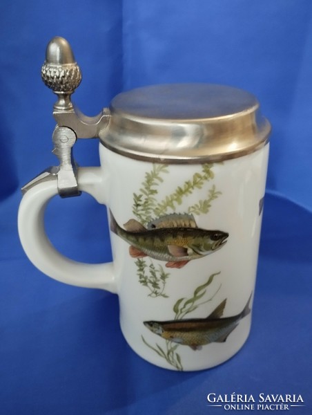Jug depicting fish with a tin lid