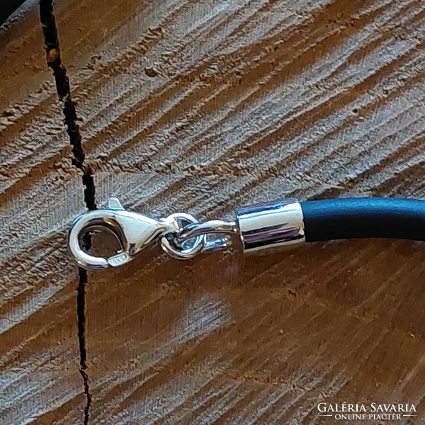 A very special silver moon pendant on a rubber chain