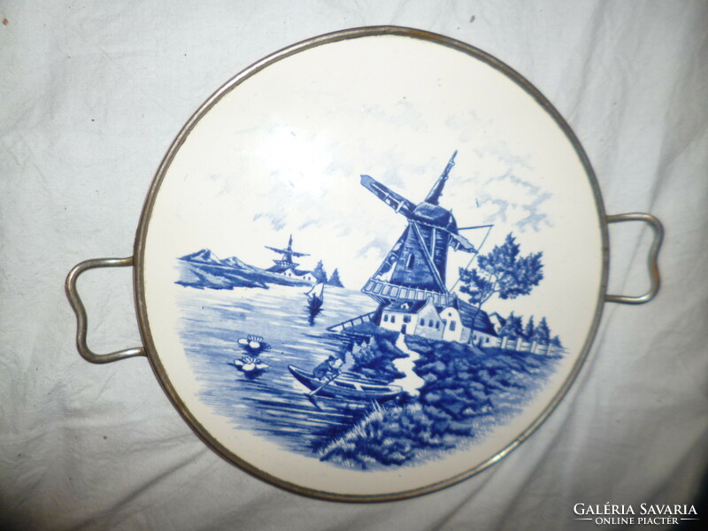 Offering an old delft porcelain earthenware coaster