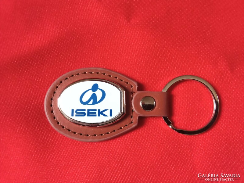 Iseki metal keychain on a leather background