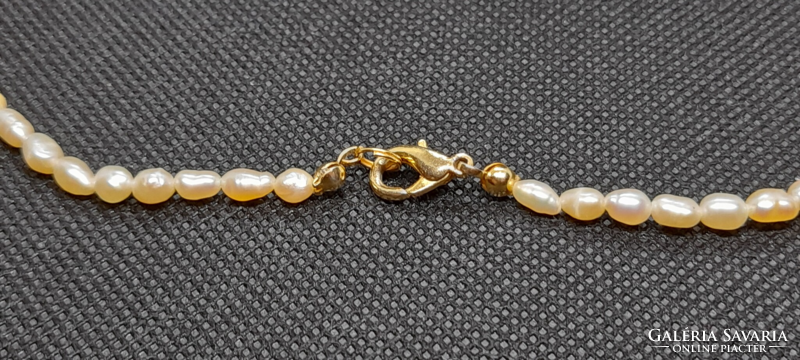 Freshwater rice grain cultured pearl string of 4-6 mm pearls.