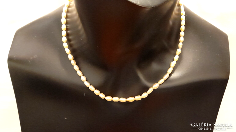 Freshwater rice grain cultured pearl string of 4-6 mm pearls.