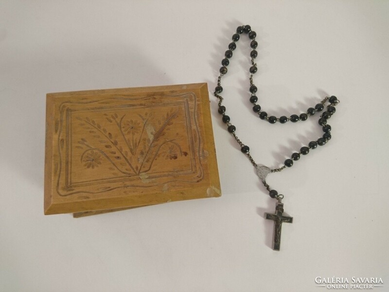 Old antique rosary, reader, crucifix in a carved wooden box