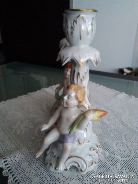 Baroque porcelain putto candle holders with beautiful flower decoration by hand, together.