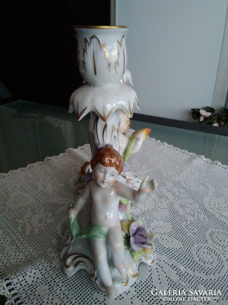 Baroque porcelain putto candle holders with beautiful flower decoration by hand, together.