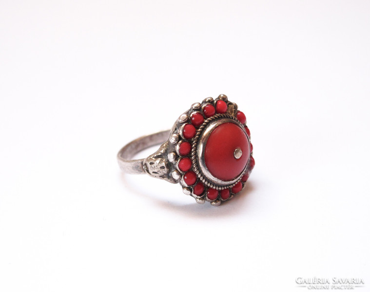 Old silver ring with coral.