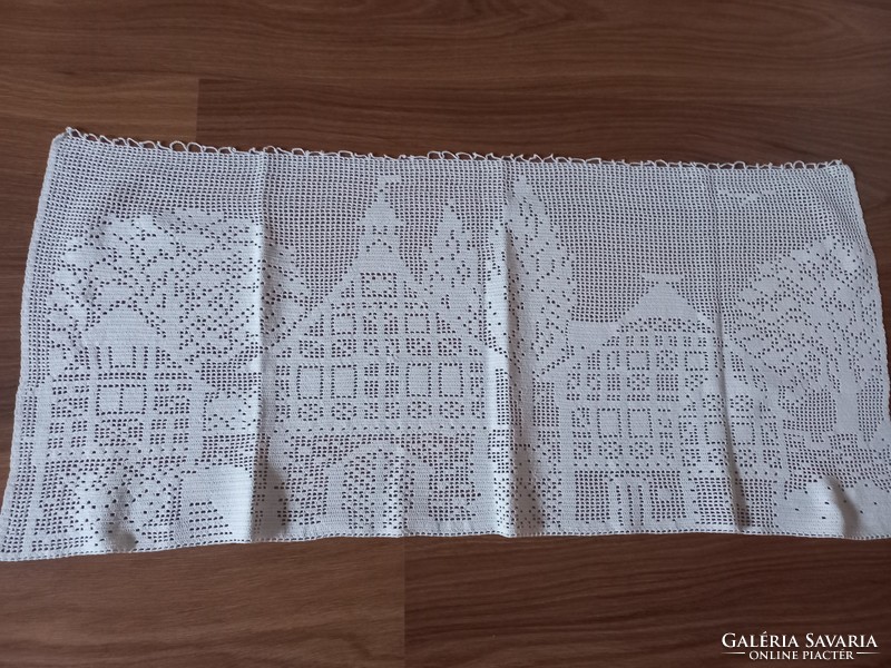 Old, hand-crocheted stained glass curtain with houses