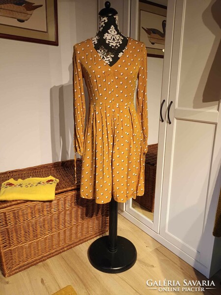 Orsay women's dress with a pattern on a yellow background