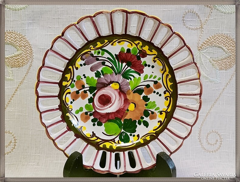 Handcrafted ceramic decorative plate with an openwork edge.