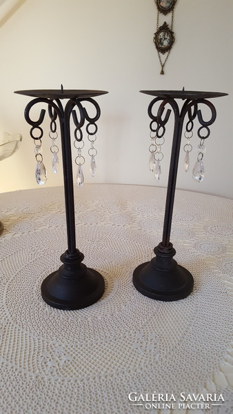 A pair of wrought iron candle holders with crystal glass pendants