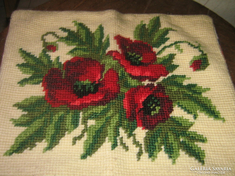 Decorative pillow sewn with a beautiful hand-embroidered flower pattern poppy tapestry stitch