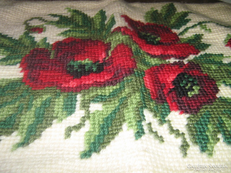 Decorative pillow sewn with a beautiful hand-embroidered flower pattern poppy tapestry stitch