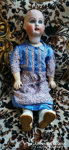 A doll with a large porcelain head