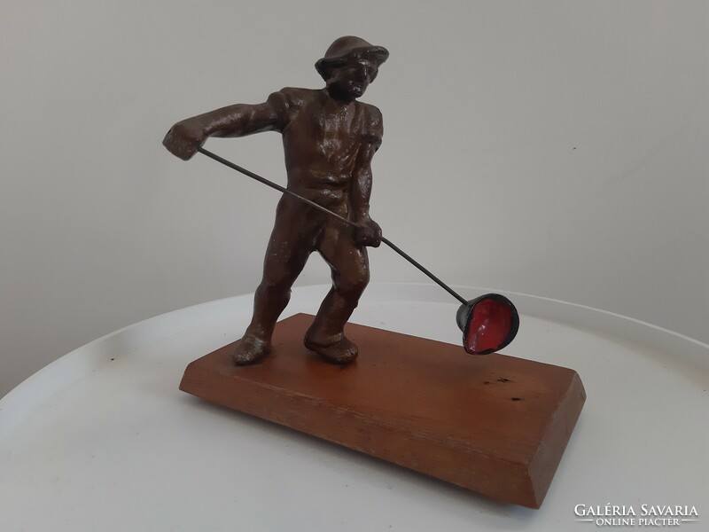 Szoreal foundry worker on a wooden pedestal