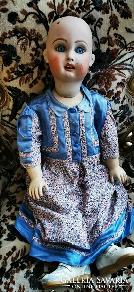 A doll with a large porcelain head