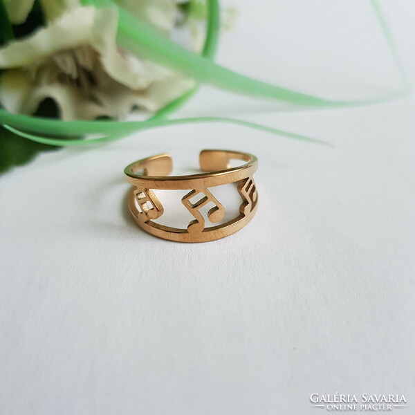 New, gold-colored, dimensionless ring decorated with engraved musical notes