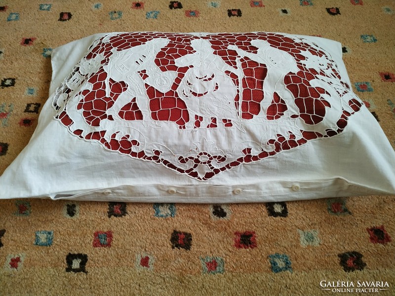An old decorative cushion cover with a hinged scene