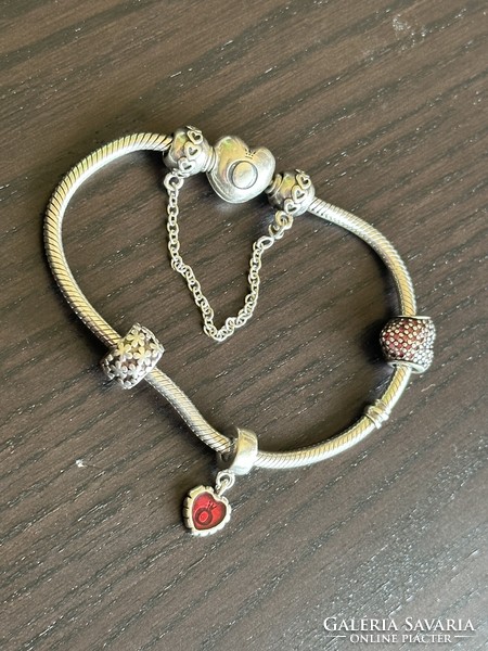 Silver pandora bracelet with several charms