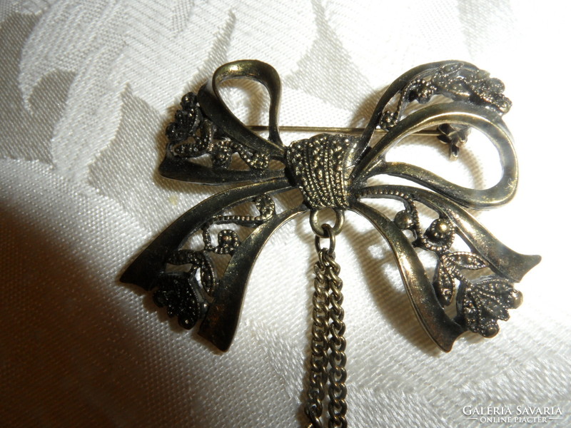 Older bow-shaped metal badge, brooch