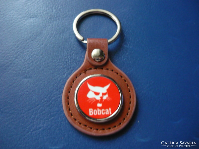Bobcat metal key ring on a leather base