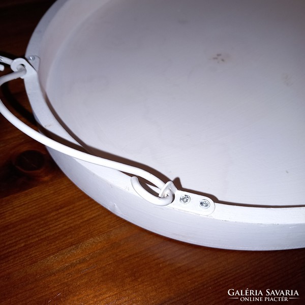 Oval shaped wooden tray with metal tabs.