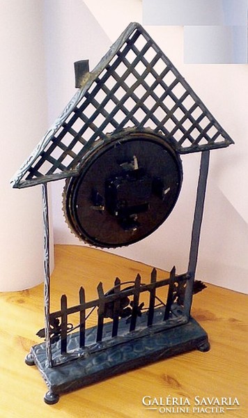 Wrought iron cottage-shaped fireplace with quartz structure and extruded metal decorative elements