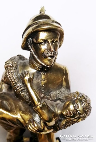 Child rescue firefighter, sports relic with a bronze effect