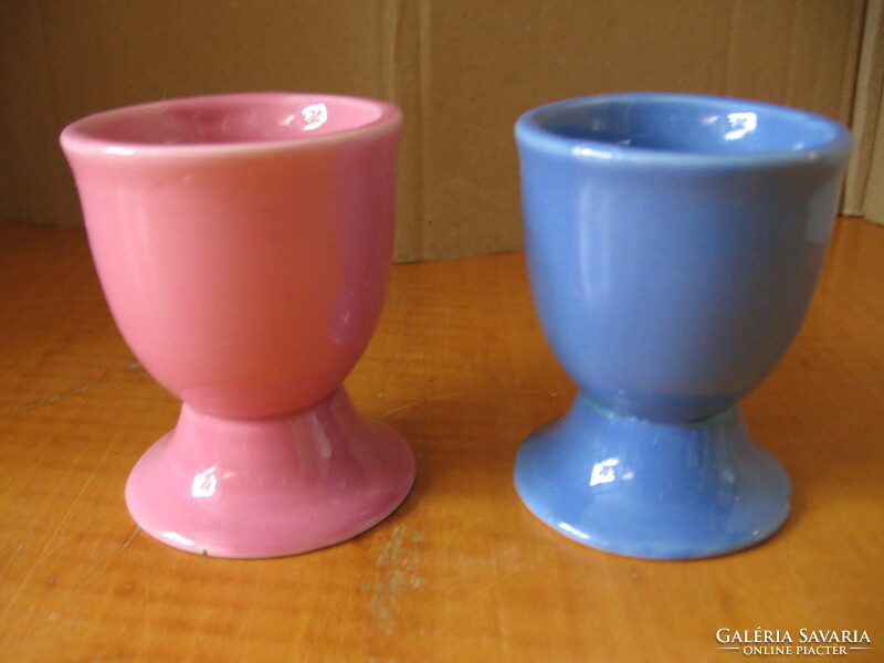 A pair of egg holders with funny face noses